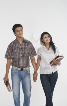 College students walking with holding hands