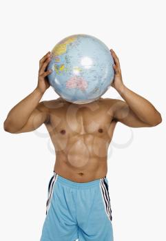 Close-up of a man holding a globe