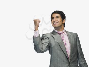 Businessman clenching fist in excitement