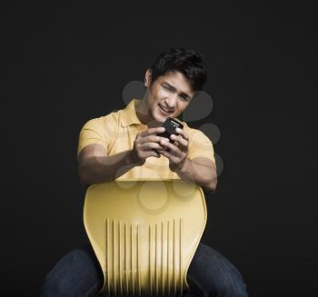 Man text messaging on a mobile phone