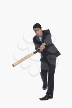 Businessman playing baseball
