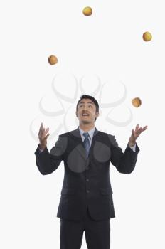 Businessman juggling with apples