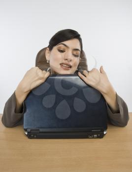Businesswoman hugging a laptop