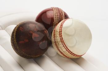 Close-up of cricket balls on cricket pads