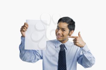 Businessman showing a sheet of blank paper