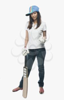 Portrait of a female cricket fan holding a bat and a ball