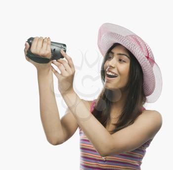 Close-up of a woman filming herself with a home video camera