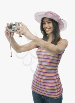 Woman taking a picture with a digital camera