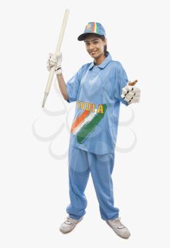 Portrait of a female cricketer holding a cricket stump and cheering