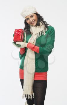 Woman holding a gift box and smiling
