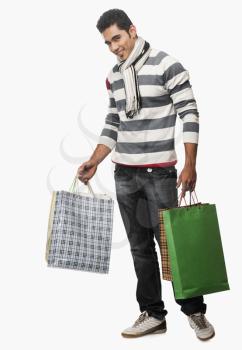 Portrait of a man carrying shopping bags