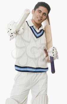 Portrait of a cricket batsman showing a stump