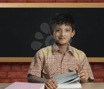 Boy imitating a teacher in a classroom