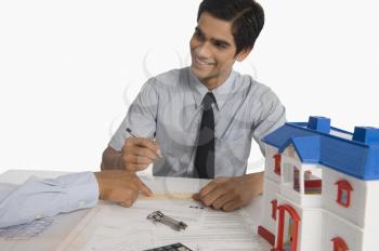 Real estate agent discussing a document with a customer