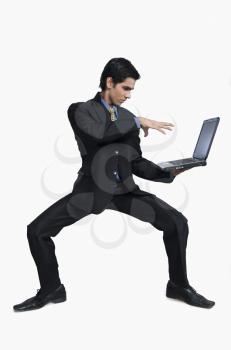 Businessman doing magic on a laptop