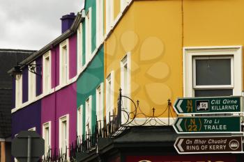 Low angle view of directional signs with buildings, Kenmare, County Kerry, Republic of Ireland