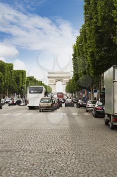 Traffic with triumphal arch in the background, Arc de Triomphe, Avenue des Champs-Elysees, Paris, France