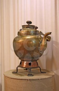 ancient copper teapot on stand