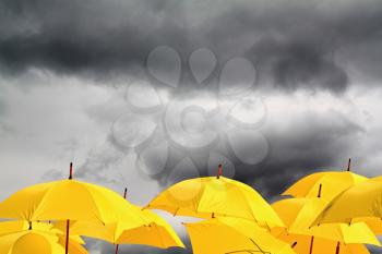 yellow umbrellas on cloudy background