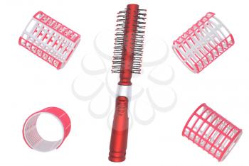 Hair curlers and hairbrush on a white background.                   