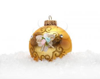 Gold Christmas balls in snow