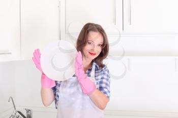 woman in kitchen with empty plate