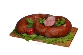 Smoked sausage with tomato and lettuce on wooden board.
