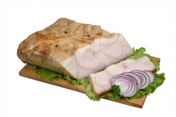 Smoked lard with onion and lettuce on wooden board.