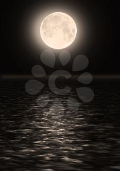 The full moon in the night sky over water