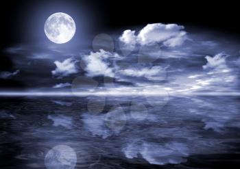 The full moon in clouds over water