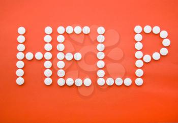 Royalty Free Photo of a Help Sign Written in Pills