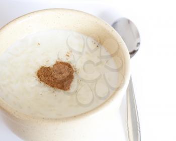 Royalty Free Photo of a Bowl of Rice Pudding with a Cinnamon Heart Shape
