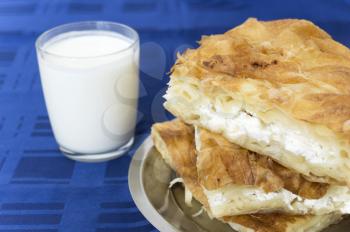 Royalty Free Photo of a Burek and Cup of Yoghurt
