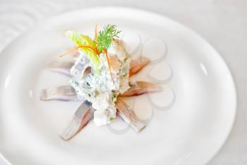 Marinated herring fillets  on a white plate