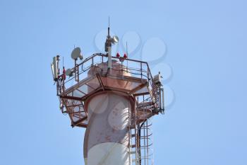 Antennas for cellular telephone communication on a large chimney.