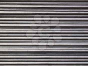 Corrugated steel shutter useful as a background