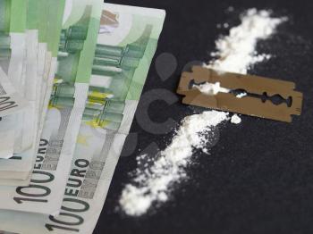 Cocaine, razor blade and money (simulation using wheat flour, no actual drugs used)