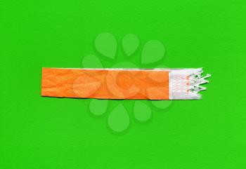 wristband used as event ticket, orange over green