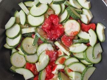 Courgettes vegetables with tomato sauce in a frying pan