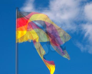 The national German flag of Germany floating in the wind