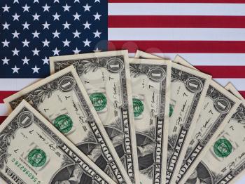 One Dollar banknotes (USD) currency money over the flag of the United States