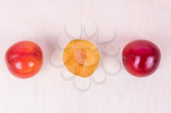 Red and yellow plum fruit on the white background isolated top view