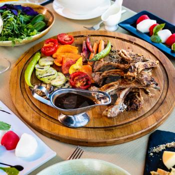 Lamb and mutton, sheep meat, kebab, vegetables on the wooden plate