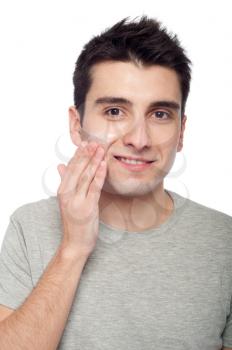 Royalty Free Photo of a Man Applying Eye Cream