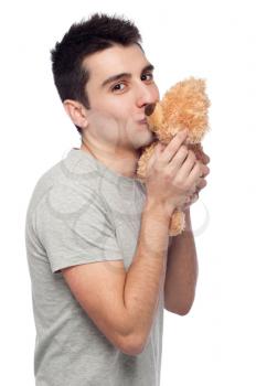 Royalty Free Photo of a Man Kissing a Teddy Bear