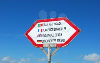 Royalty Free Photo of a Sign at the Beach in Different Languages