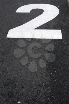 Royalty Free Photo of a Number Two Painted on Asphalt