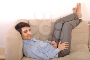 Royalty Free Photo of a Man Relaxing on a Couch