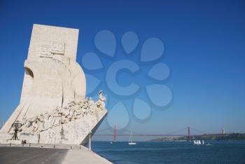 Royalty Free Photo of the Monument of Navigators Statues in a Stone Caravel