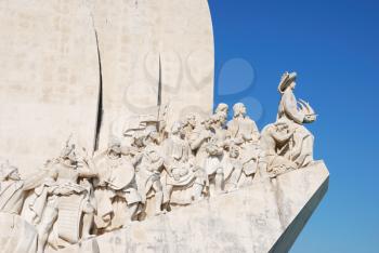 Royalty Free Photo of the Monument of Navigators Statues in a Stone Caravel